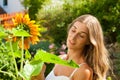 Garden in summer Ã¢â¬â happy woman with flowers